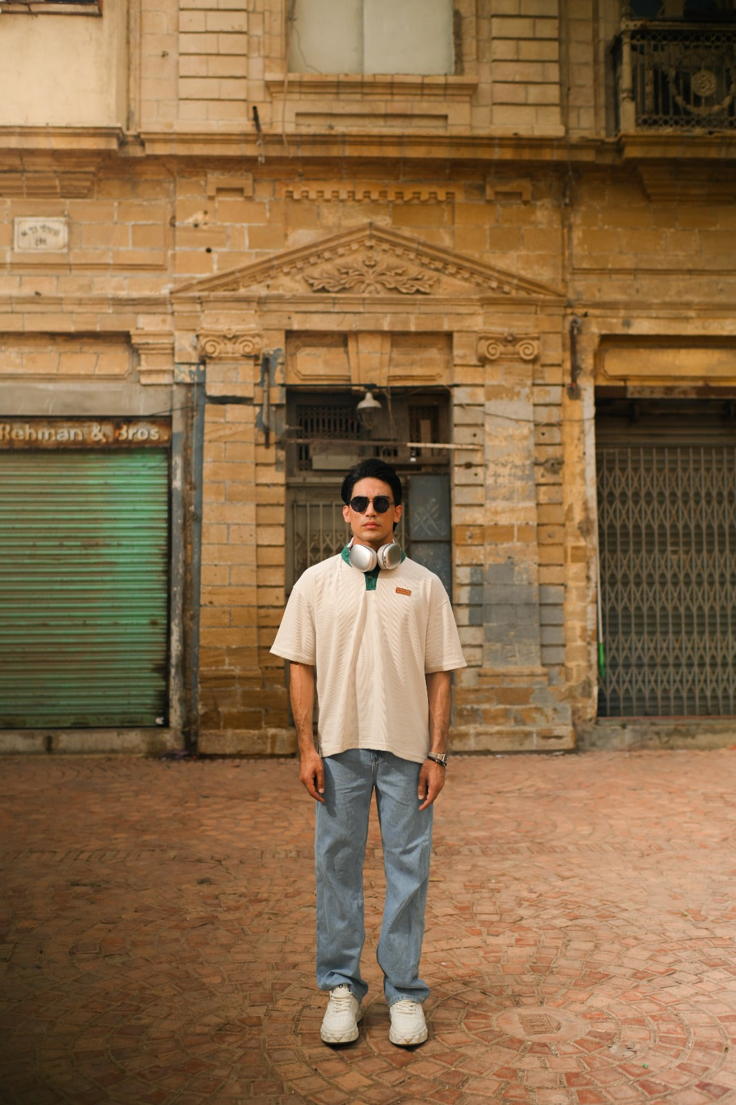 "Textured knit oversized polo shirt in off-white, perfect for minimalist street style"