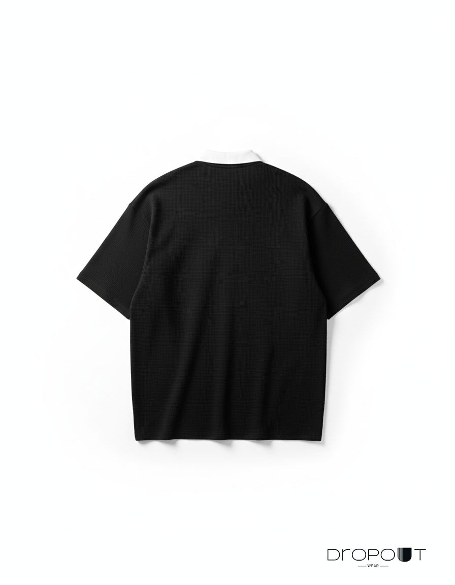 "Unisex black oversized polo shirt in waffle knit with drop shoulders and classic collar"