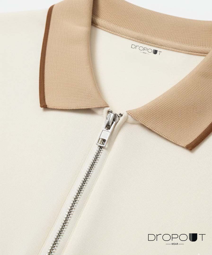 Close-up of a white zipper polo with brown collar featuring the Dropoutwear brand.
