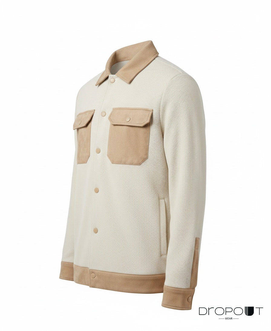 “Front view of a camel suede-trimmed knitted shacket featuring suede on the collar, cuffs, hem, and pockets, with two handmade brass buttons wrapped in suede.”